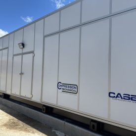 Large white industrial air compressor unit with logos for Compression Mechanical and CASEiZ Compressed Air Solutions.